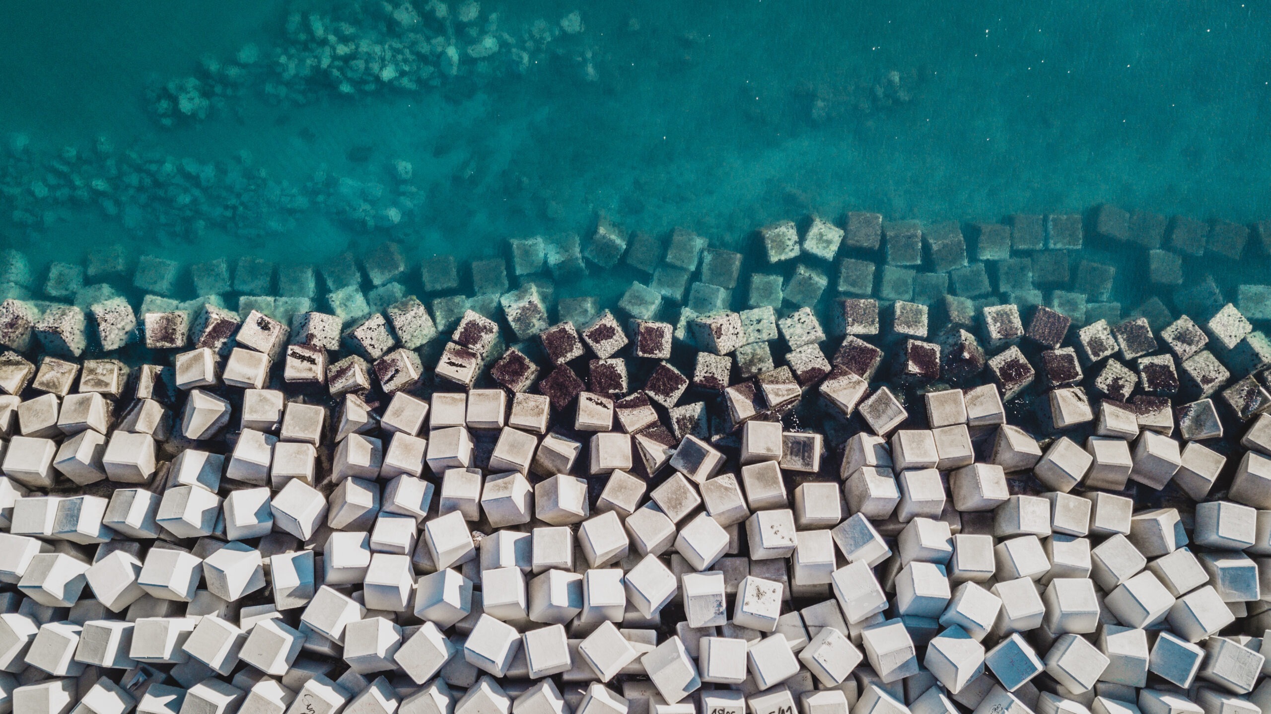 Aerial view of cement cube blocks protecting the shore from the waves in the port of Malaga, Spain.